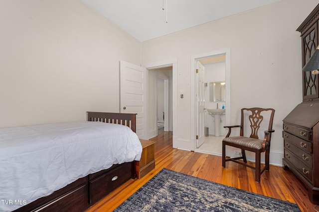 215 Clinchfield Ave, Erwin, TN 37650 - bedroom with light wood-style floors, baseboards, ensuite bath, and a sink