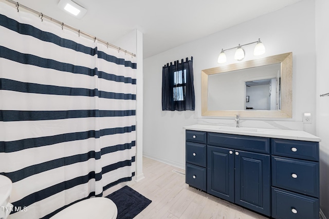 215 Clinchfield Ave, Erwin, TN 37650 - full bathroom with vanity, toilet, wood finished floors, a shower with curtain, and baseboards