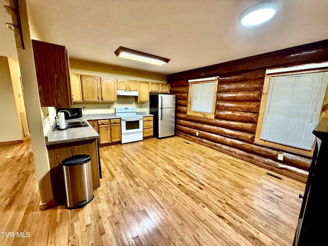 366 Judge Ben Allen Rd, Elizabethton, TN 37643 - kitchen featuring freestanding refrigerator, white range with electric stovetop, rustic walls, a sink, and under cabinet range hood