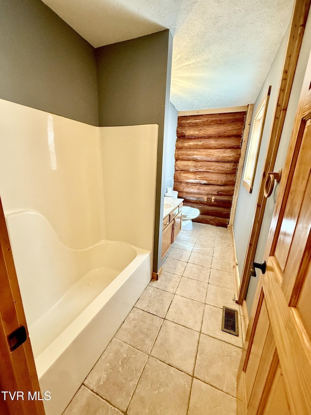 366 Judge Ben Allen Rd, Elizabethton, TN 37643 - bathroom featuring rustic walls, toilet, baseboards, tile patterned flooring, and a textured ceiling