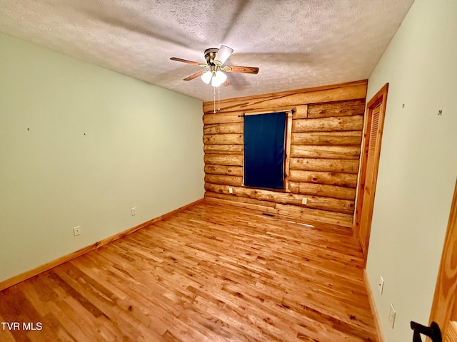 366 Judge Ben Allen Rd, Elizabethton, TN 37643 - spare room featuring rustic walls, wood finished floors, a textured ceiling, baseboards, and a ceiling fan