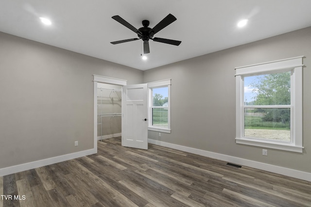 5980 Snapps Ferry Rd, Afton, TN 37616 - unfurnished bedroom with baseboards, dark wood-style floors, multiple windows, a walk in closet, and recessed lighting