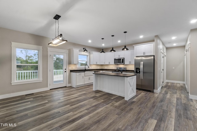 5980 Snapps Ferry Rd, Afton, TN 37616 - kitchen with appliances with stainless steel finishes, dark countertops, dark wood-style flooring, white cabinets, and recessed lighting