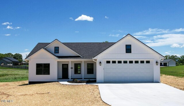 5980 Snapps Ferry Rd, Afton, TN 37616 - modern farmhouse with a porch, concrete driveway, a garage, and a shingled roof