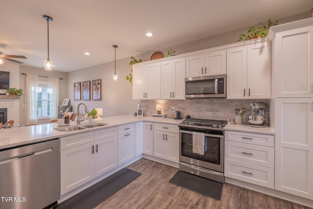 4073 Maize Pl, Piney Flats, TN 37686 - kitchen with stainless steel appliances, a sink, white cabinets, tasteful backsplash, and dark wood-type flooring