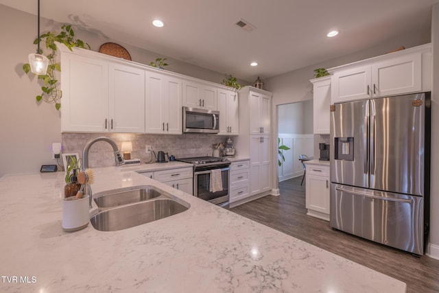 4073 Maize Pl, Piney Flats, TN 37686 - kitchen with stainless steel appliances, a sink, white cabinets, light stone countertops, and dark wood-style flooring