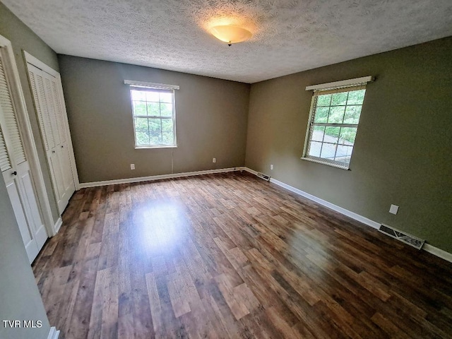 226 Heritage Hills Dr, Greeneville, TN 37745 - unfurnished bedroom with dark wood finished floors, baseboards, and a textured ceiling