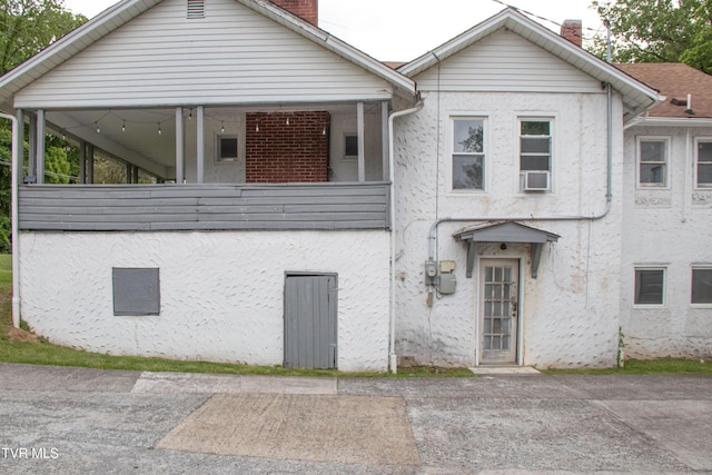1416 E Cedar St, Bristol, TN 37620 - view of front of home featuring a chimney, stucco siding, and cooling unit