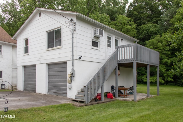 1416 E Cedar St, Bristol, TN 37620 - rear view of house featuring a yard, a garage, a wooden deck, stairway, and driveway