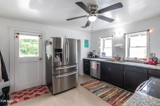 1416 E Cedar St, Bristol, TN 37620 - kitchen featuring stainless steel appliances, a sink, light tile patterned floors, ceiling fan, and light stone counters