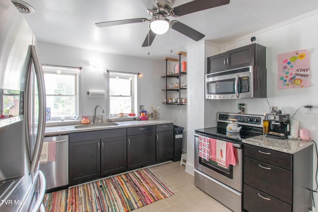 1416 E Cedar St, Bristol, TN 37620 - kitchen with stainless steel appliances, a sink, light tile patterned flooring, a ceiling fan, and light stone counters