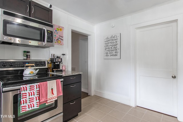 1416 E Cedar St, Bristol, TN 37620 - kitchen with stainless steel appliances, light tile patterned floors, light stone countertops, crown molding, and baseboards