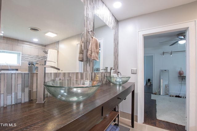 1416 E Cedar St, Bristol, TN 37620 - bathroom with double vanity, curtained shower, ceiling fan, and tasteful backsplash