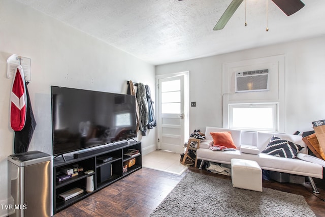1416 E Cedar St, Bristol, TN 37620 - living room featuring wood finished floors, a textured ceiling, an AC wall unit, and ceiling fan
