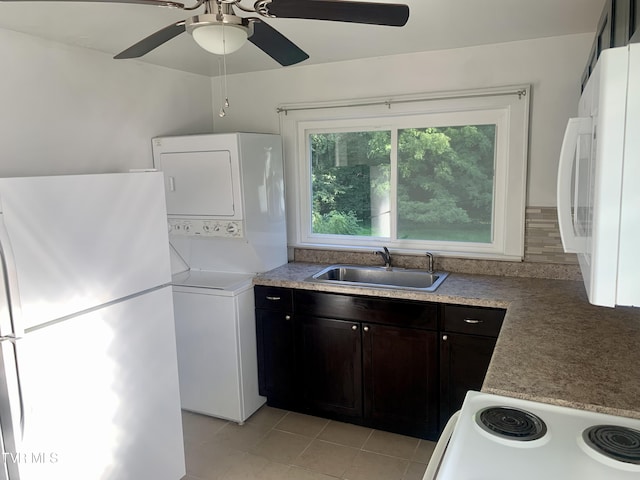 1416 E Cedar St, Bristol, TN 37620 - kitchen with a sink, stacked washing machine and dryer, white appliances, light tile patterned floors, and ceiling fan