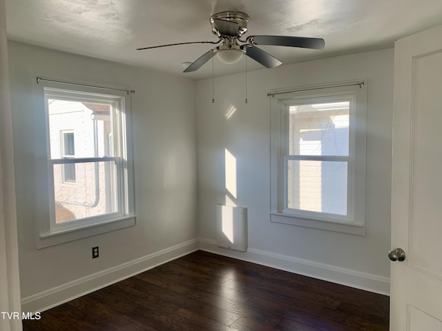 1416 E Cedar St, Bristol, TN 37620 - empty room featuring plenty of natural light, baseboards, dark wood-style flooring, and a ceiling fan