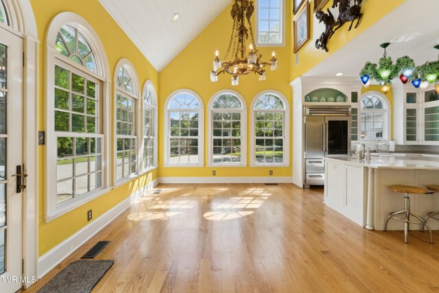 133 Knob Creek Dock Rd, Johnson City, TN 37601 - unfurnished sunroom with plenty of natural light, a chandelier, a sink, vaulted ceiling, and french doors