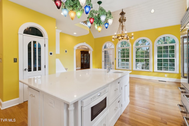 133 Knob Creek Dock Rd, Johnson City, TN 37601 - kitchen with white microwave, a chandelier, light wood-type flooring, white cabinets, and recessed lighting