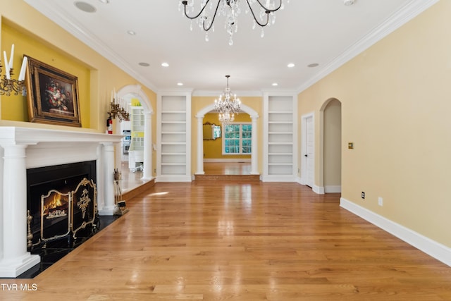 133 Knob Creek Dock Rd, Johnson City, TN 37601 - unfurnished living room featuring a chandelier, built in shelves, arched walkways, light wood-style flooring, and recessed lighting