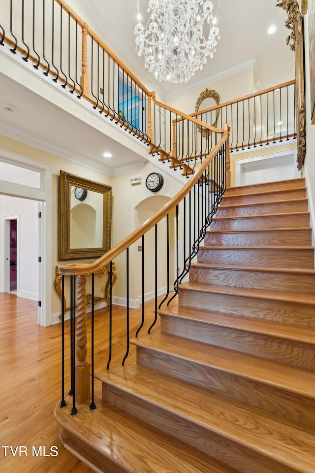 133 Knob Creek Dock Rd, Johnson City, TN 37601 - stairway featuring ornamental molding, a chandelier, wood finished floors, baseboards, and a towering ceiling
