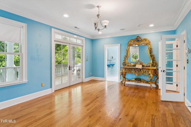 133 Knob Creek Dock Rd, Johnson City, TN 37601 - unfurnished room featuring french doors, healthy amount of natural light, a chandelier, ornamental molding, and light wood-style floors