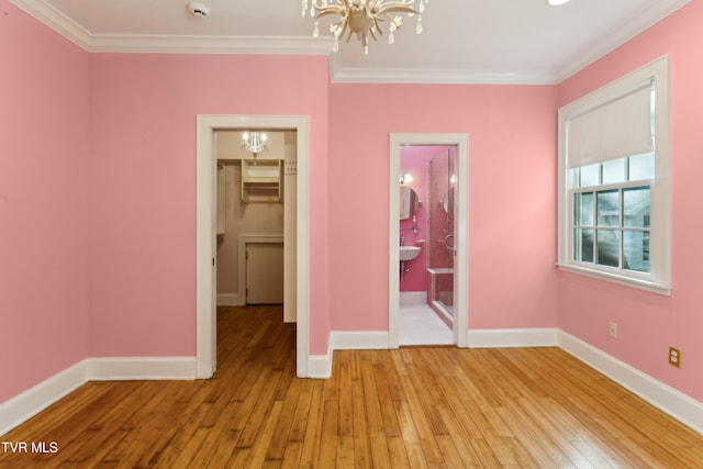 133 Knob Creek Dock Rd, Johnson City, TN 37601 - unfurnished bedroom featuring a chandelier, crown molding, light wood-style flooring, a spacious closet, and baseboards
