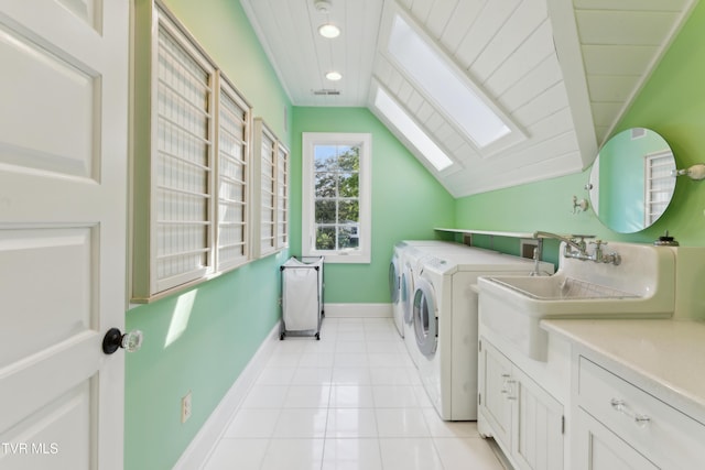 133 Knob Creek Dock Rd, Johnson City, TN 37601 - washroom featuring cabinet space, washer and dryer, a skylight, baseboards, and light tile patterned floors