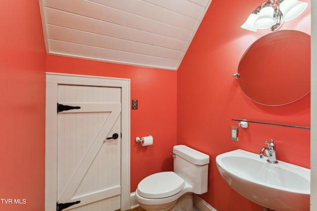 133 Knob Creek Dock Rd, Johnson City, TN 37601 - bathroom featuring vaulted ceiling, a sink, toilet, and baseboards