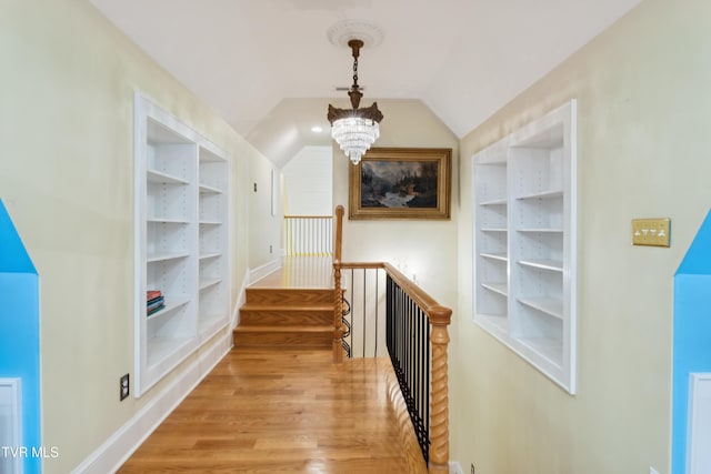 133 Knob Creek Dock Rd, Johnson City, TN 37601 - hallway featuring an upstairs landing, a chandelier, built in features, wood finished floors, and vaulted ceiling