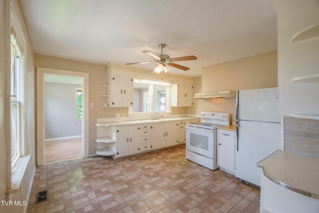 1002 Massachusetts Ave, Bristol, VA 24201 - kitchen featuring white appliances, open shelves, under cabinet range hood, light countertops, and brick patterned flooring