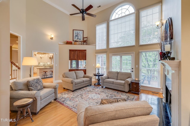 117 Quail Heights Ct, Kingsport, TN 37663 - living area with a high ceiling, ornamental molding, a ceiling fan, light wood-style flooring, and stairs