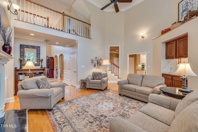 117 Quail Heights Ct, Kingsport, TN 37663 - living room featuring ornamental molding, a ceiling fan, stairway, arched walkways, and light wood-style floors