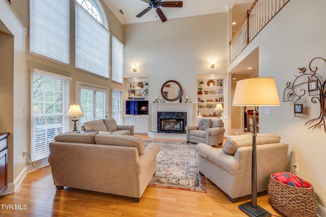 117 Quail Heights Ct, Kingsport, TN 37663 - living area with a towering ceiling, ceiling fan, light wood-type flooring, a high end fireplace, and built in features