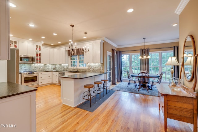 117 Quail Heights Ct, Kingsport, TN 37663 - kitchen featuring stainless steel appliances, a sink, a chandelier, crown molding, and light wood finished floors