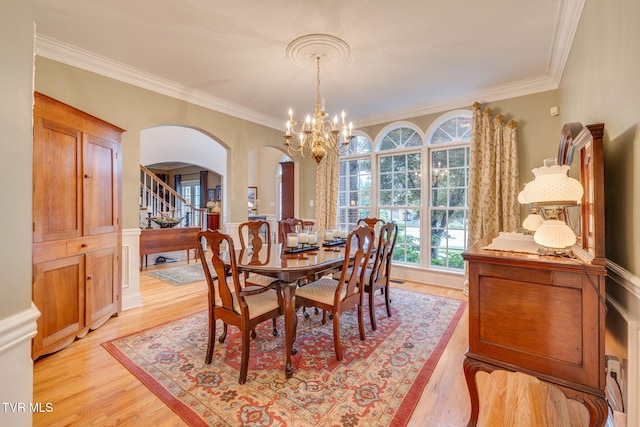 117 Quail Heights Ct, Kingsport, TN 37663 - dining room with arched walkways, a chandelier, crown molding, light wood-style floors, and stairway