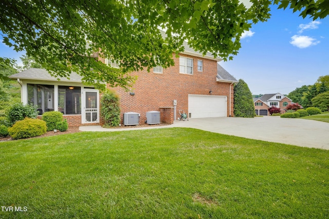 117 Quail Heights Ct, Kingsport, TN 37663 - rear view of property with driveway, a sunroom, a garage, and central air condition unit