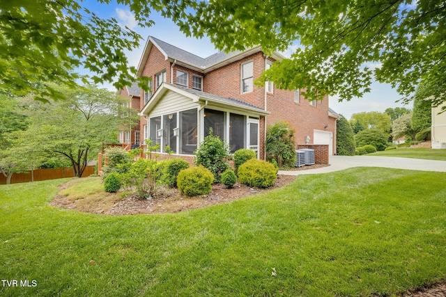 117 Quail Heights Ct, Kingsport, TN 37663 - view of front of property with a sunroom, brick siding, driveway, and a garage