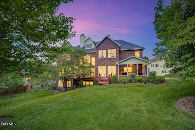 117 Quail Heights Ct, Kingsport, TN 37663 - back of property at dusk with brick siding, a chimney, and a wooden deck