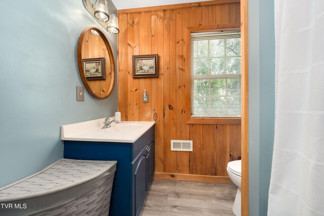 122 Spring Hollow Ln, Jonesborough, TN 37659 - full bathroom featuring vanity, toilet, wood finished floors, wood walls, and baseboards
