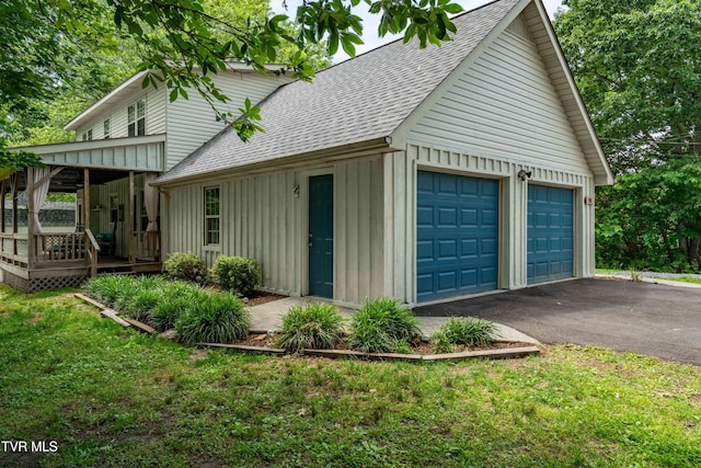 122 Spring Hollow Ln, Jonesborough, TN 37659 - view of side of property featuring a shingled roof, board and batten siding, a garage, a wooden deck, and a lawn