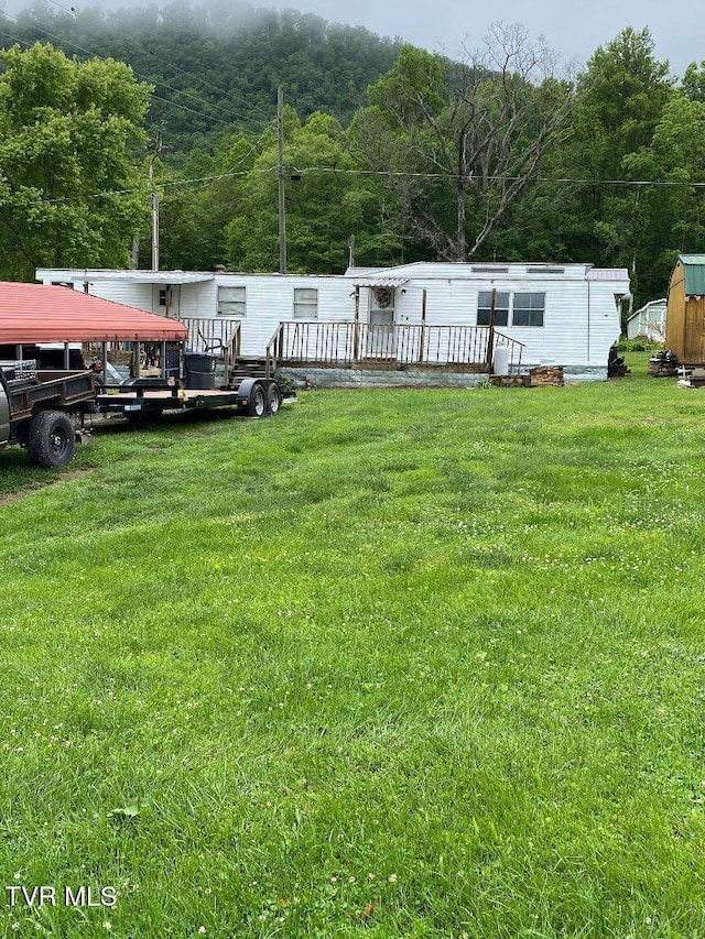2807 E 6th Ave, Big Stone Gap, VA 24219 - view of grassy yard with a forest view and a wooden deck