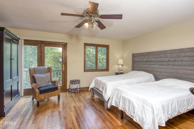 14346 White Top Vw, Abingdon, VA 24210 - bedroom featuring access to exterior, multiple windows, wood finished floors, a textured ceiling, and baseboards