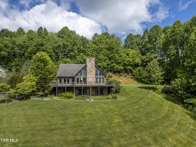 14346 White Top Vw, Abingdon, VA 24210 - rear view of house featuring a lawn, stone siding, a wooden deck, a chimney, and a view of trees