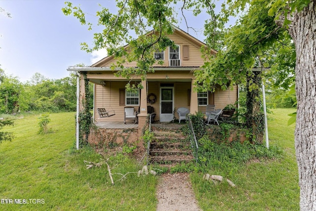 2170 Lone Mountain Rd, Tazewell, TN 37879 - bungalow-style home featuring a front lawn and covered porch