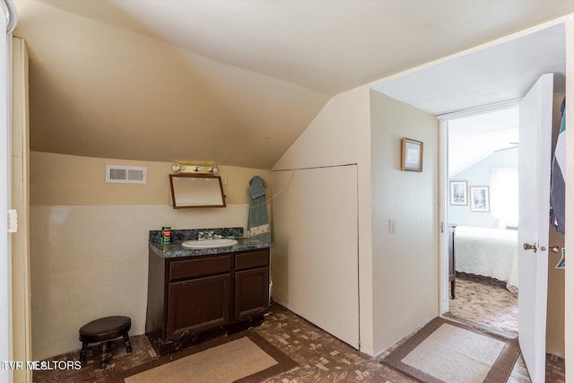 2170 Lone Mountain Rd, Tazewell, TN 37879 - bathroom featuring vanity, lofted ceiling, and connected bathroom