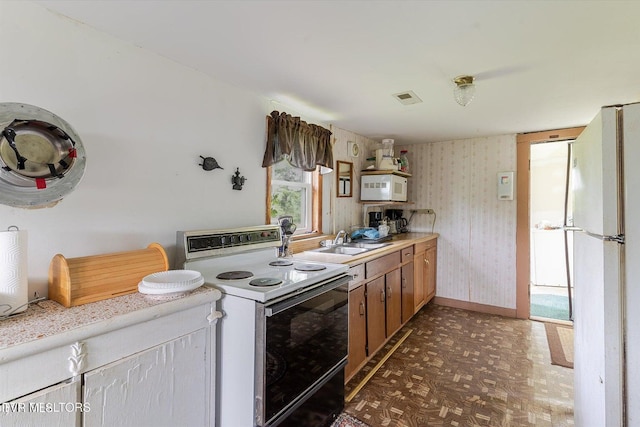 2170 Lone Mountain Rd, Tazewell, TN 37879 - kitchen with white appliances, wallpapered walls, a sink, baseboards, and light countertops