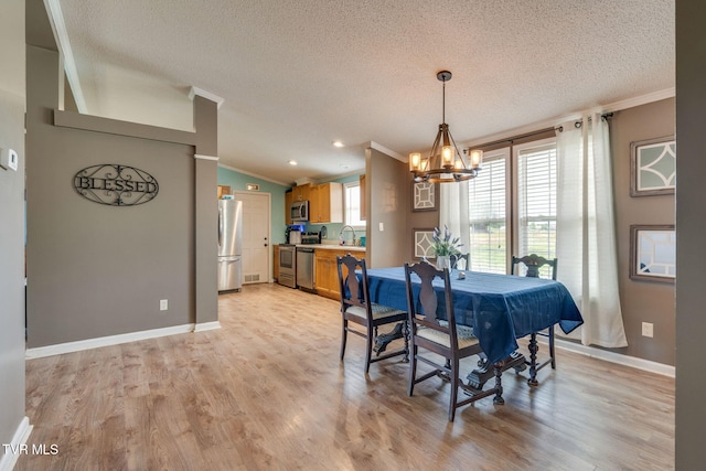 1734 Clear Springs Rd, Limestone, TN 37681 - dining space featuring ornamental molding, a chandelier, a textured ceiling, light wood-style flooring, and baseboards
