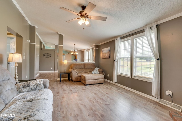 1734 Clear Springs Rd, Limestone, TN 37681 - living area featuring ornamental molding, a chandelier, plenty of natural light, a ceiling fan, and a textured ceiling