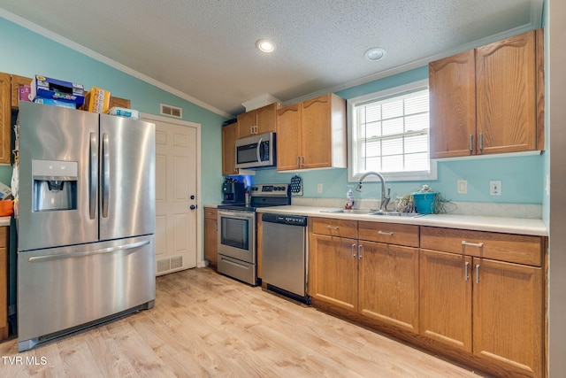 1734 Clear Springs Rd, Limestone, TN 37681 - kitchen featuring appliances with stainless steel finishes, a sink, crown molding, a textured ceiling, and light countertops