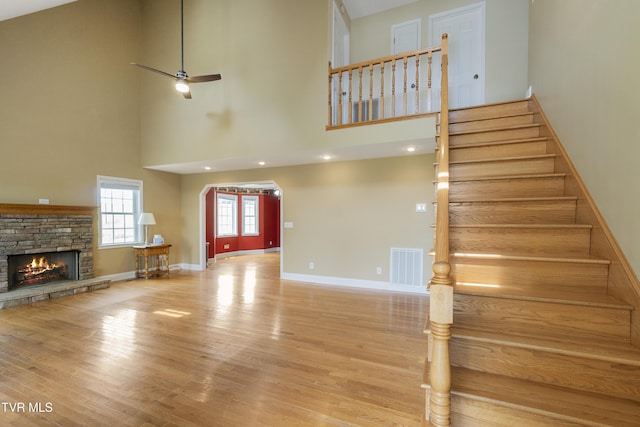2361 Old Stage Rd, Afton, TN 37616 - unfurnished living room with a towering ceiling, wood finished floors, stairs, a fireplace, and baseboards